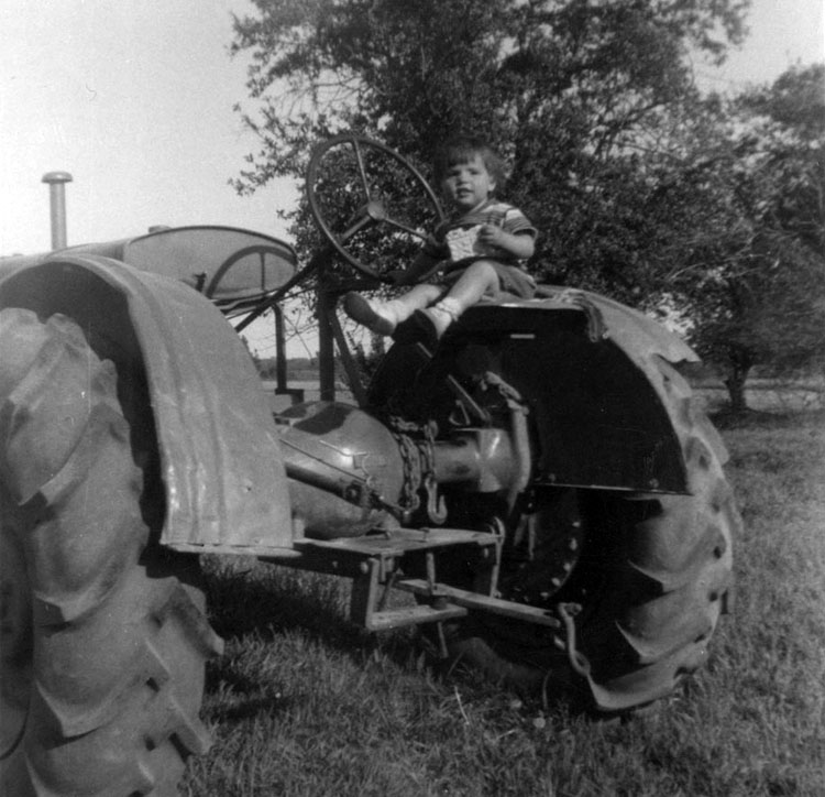 Me at 20 months old sitting on a tractor on our farm